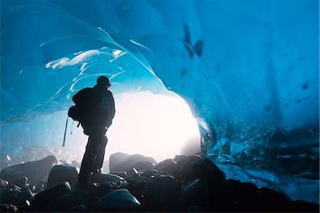 entrance - A hiker looks out the entrance of an ice cave in the Mendenhall Glacier, Juneau, Southeast Alaska, Summer Stock Photo - Rights-Managed, Code: 854-03362476
