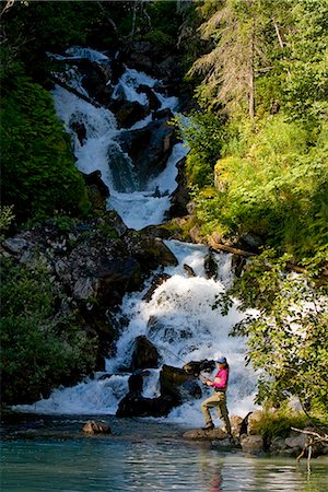 Woman spin fishing for salmon at the base of Fisher Falls at Big River Lakes in Redoubt Bay State Critical Habitat Area, Southcentral Alaska Stock Photo - Rights-Managed, Code: 854-03538053