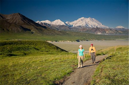 A young couple walk along a hard path near the Eielson visitor center with MtMcKinley in the background Denali NP Alaska Stock Photo - Rights-Managed, Code: 854-03538151