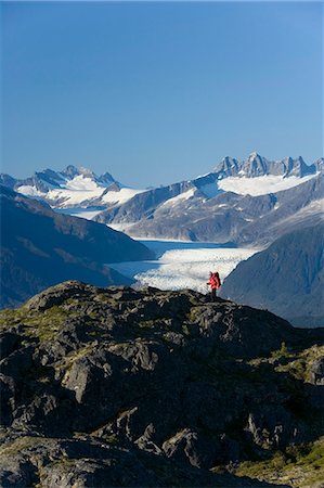 Man hiking in Alaska's Tongass National Forest with view of Mendenhall Glacier near Juneau Alaska southeast Autumn Stock Photo - Rights-Managed, Code: 854-03538226