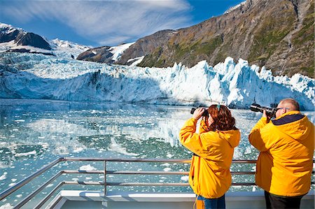 simsearch:854-03538698,k - Tourist couple on a Klondike Express Glacier Cruise tour view Stairway glacier (r) flowing into Surprise Glacier Harriman Fjord, Alaska Stock Photo - Rights-Managed, Code: 854-03538546