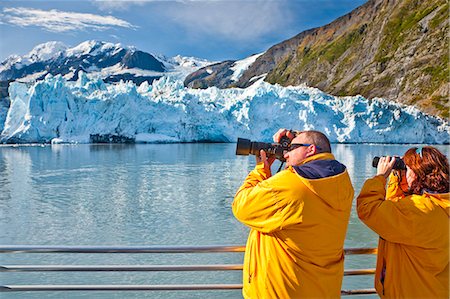 simsearch:854-03538698,k - Tourist couple on a Klondike Express Glacier Cruise tour view Stairway glacier (r) flowing into Surprise Glacier Harriman Fjord, Alaska Stock Photo - Rights-Managed, Code: 854-03538547