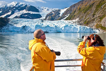 simsearch:854-03538698,k - Tourist couple on a Klondike Express Glacier Cruise tour view Stairway glacier (r) flowing into Surprise Glacier Harriman Fjord, Alaska Stock Photo - Rights-Managed, Code: 854-03538548