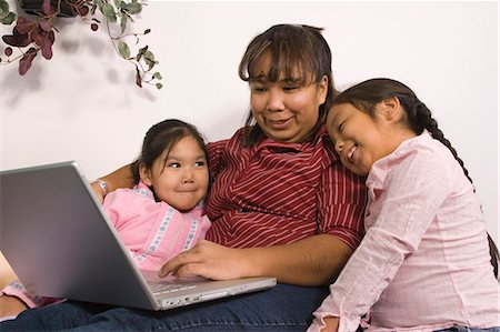 AK native children w/mother reading book & using computer together @ home Tlingit/Athabascan Stock Photo - Rights-Managed, Code: 854-03538874