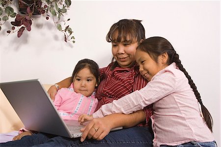 AK native children w/mother reading book & using computer together @ home Tlingit/Athabascan Stock Photo - Rights-Managed, Code: 854-03538872