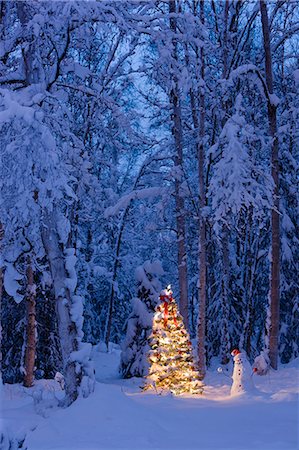 Snowman with santa hat hanging ornaments on a  Christmas tree in a snow covered birch forest in Southcentral Alaska Stock Photo - Rights-Managed, Code: 854-03539039