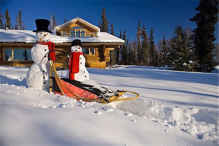 deep woods - Large & small snowman ride on dog sled in deep snow in afternoon in front of log cabin style home Fairbanks Alaska winter Stock Photo - Rights-Managed, Code: 854-03539265