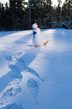 funny freezing cold photos - Snowman walking w/snowshoes leaving tracks in snow drift late afternoon Alaska Winter Stock Photo - Rights-Managed, Code: 854-03539300