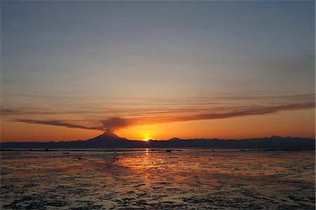 erupting volcano - Ash cloud rises from Mt. Redoubt at sunset during low tide near Ninilchik, Alaska Stock Photo - Rights-Managed, Code: 854-03539317