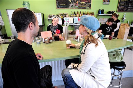 A couple visit over a cup of coffee at Snow City Cafe in Downtown Anchorage, Southcentral Alaska, Summer/n Stock Photo - Rights-Managed, Code: 854-03646285