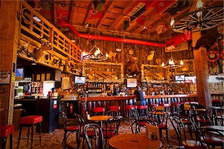 Tourist sits at the bar of the Red Dog Saloon in Juneau, Southeast Alaska, Summer Stock Photo - Rights-Managed, Code: 854-03646300