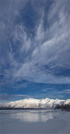 Cirrus clouds loom over an icy Knik River and snow covered Talkeetna Mountains in Knik River Valley near Knik River Bridge, Matanuska Susitna Valley, Southcentral Alaska, Winter Stock Photo - Rights-Managed, Code: 854-03646721