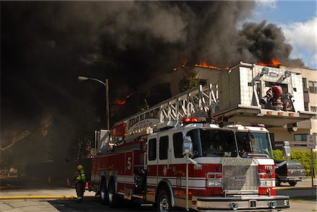 fire trucks with fire - Anchorage Fire Department Station Five responds to a massive fire in the North Building of the Park Place Condominiums in Downtown, Anchorage, Southcentral Alaska, Summer Stock Photo - Rights-Managed, Code: 854-03646802