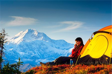 family sunset outdoor - Woman talking on her cell phone while camping with the south summit of Mt. McKinley in the background, Peters Hills, Denali State Park, Southcentral Alaska, Fall/n Stock Photo - Rights-Managed, Code: 854-03646849