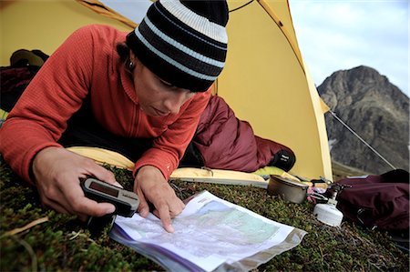 Woman in a tent consults a GPS and map while camping at Rabbit Lake, Chugach State Park, Southcentral Alaska, Autumn Stock Photo - Rights-Managed, Code: 854-03739547