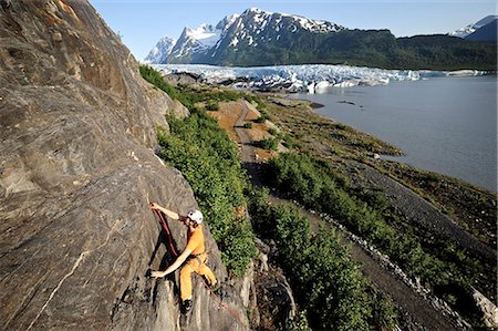 strength concept scenic - Man rock climbing with Spencer Glacier in the background, Chugach National Forest, Kenai Peninsula, Southcentral Alaska, Summer Stock Photo - Rights-Managed, Code: 854-03739542