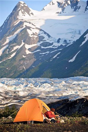 door equipment - Woman prepares food on a backpacking stove while in her tent with Spencer Glacier and Chugach Mountains in the background, Chugach National Forest, Southcentral Alaska, Summer Stock Photo - Rights-Managed, Code: 854-03739555