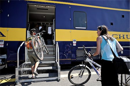 Two female bicyclists board the Alaska Railroad's Chugach Explorer in Portage for a whistle stop trip to Spencer Glacier, Southcentral Alaska, Summer Foto de stock - Con derechos protegidos, Código: 854-03739659