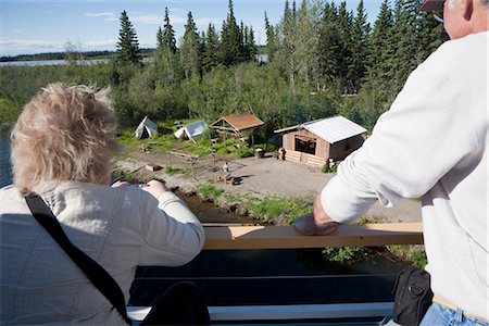 sternwheeler - Tourists watch a Alaskan native fish camp demonstration from the Riverboat Discovery along the Chena River, Fairbanks, Interior Alaska, Summer Stock Photo - Rights-Managed, Code: 854-03739778