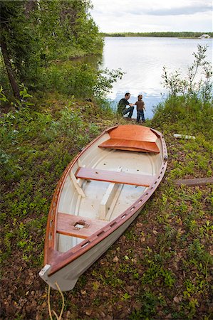 simsearch:854-03740267,k - Father kneels next to his toddler son on the shore of Willow Lake with a small wooden boat in the foreground, Mat-Su Valley, Southcentral Alaska, Summer Stock Photo - Rights-Managed, Code: 854-03740022