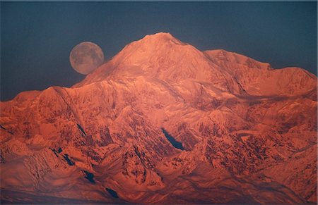 snow capped mountains - The full moon sets behind Mt. McKinley lit by alpenglow at sunset, near Talkeetna, Southcentral Alaska Stock Photo - Rights-Managed, Code: 854-03740318