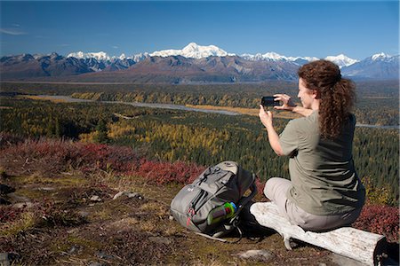 Female hiker photographs the view of Mt. Mckinley and Alaska Range from Kesugi Ridge Trail near Little Coal Creek trailhead, Denali State Park, Southcentral Alaska, Autumn Stock Photo - Rights-Managed, Code: 854-03844954
