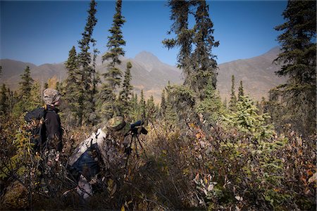 seasonal lake - Male bow hunter and son use a spotting scope to look for moose while hunting, Eklutna Lake area, Chugach State Park, Southcentral Alaska, Autumn Stock Photo - Rights-Managed, Code: 854-03844997