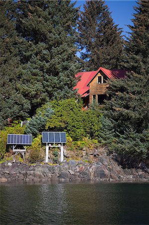 pacific coast usa alaska - Scenic view of a log home powered by solar panels in Anton Larsen Bay, Kodiak Island, Southwest Alaska, Summer Stock Photo - Rights-Managed, Code: 854-03845244