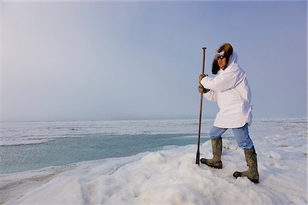 summer eskimo parka - Male Inupiaq Eskimo hunter wearing his Eskimo parka (Atigi) and carrying a walking stick while looking out over the Chukchi Sea, Barrow, Arctic Alaska, Summer Stock Photo - Rights-Managed, Code: 854-03845503