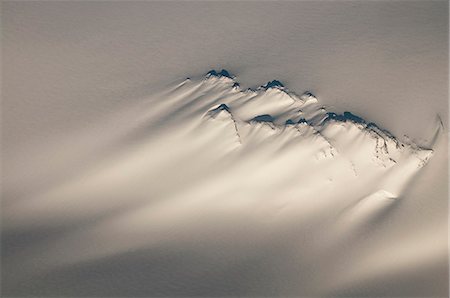 Aerial of a windswept nunatak on the Harding Ice Field in Kenai Fjords National Park, Southcentral Alaska, Winter Stock Photo - Rights-Managed, Code: 854-03846052