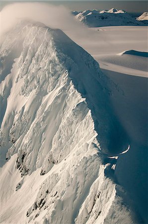 Strong winds sweep snows over a peak on the Harding Ice Field in Kenai Fjords National Park, Southcentral Alaska, Winter Stock Photo - Rights-Managed, Code: 854-03846053