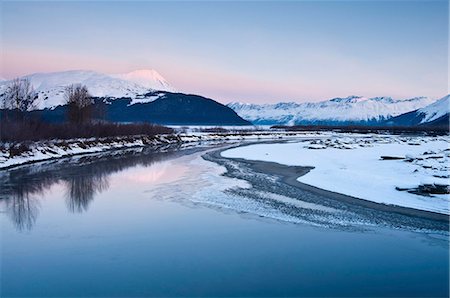 sun stream - Morning alpenglow on the Kenai Mountains along the Turnagain Arm reflects in the outfall of Portage Creek, Southcentral Alaska, Winter Stock Photo - Rights-Managed, Code: 854-03846072