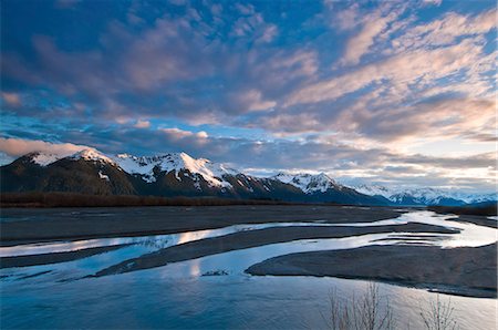 dramatic - Morning light over the Chugach Mountains reflects in the braided Scott River in the Chugach National Forest, Southcentral Alaska, Spring Stock Photo - Rights-Managed, Code: 854-03846096