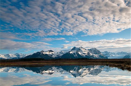 Alaganik slough reflecting the Chugach Mountains and cirrocumulus clouds in the morning, Chugach National Forest, Cordova, Southcentral Alaska, Spring Stock Photo - Rights-Managed, Code: 854-03846100