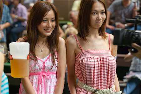 Punters unwinding over a few drink of beer at the Happy Valley Jockey Club, Hong Kong Stock Photo - Rights-Managed, Code: 855-05980999