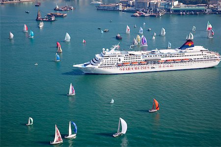 Yachting in Victoria Harbour with cruise ship in the foreground, Hong Kong Stock Photo - Rights-Managed, Code: 855-05981176