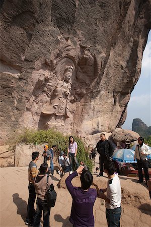 Rock carving of Buddha at the cave shrine, Roaring tiger rock Huxiaoyan, Yixiantian, Wuyi mountains, Fujian, China Stock Photo - Rights-Managed, Code: 855-05982403
