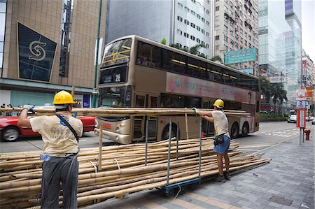 Workers arranging bamboos for scaffolding on Nathan Road, Kowloon, Hong Kong Stock Photo - Rights-Managed, Code: 855-06339065