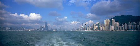 Panoramic skyline of Hong Kong island and Kowloon in Victoria Harbour, Hong Kong Stock Photo - Rights-Managed, Code: 855-06339420