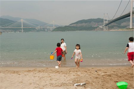 photos beach boys in asia - Kids playing at the Park Island beach, Ma Wan, Hong Kong Stock Photo - Rights-Managed, Code: 855-03252841