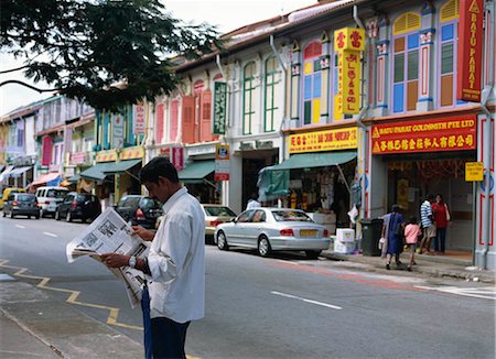 An Indian man reading newspaper on the street at Little India, Singapore Stock Photo - Rights-Managed, Code: 855-03253807