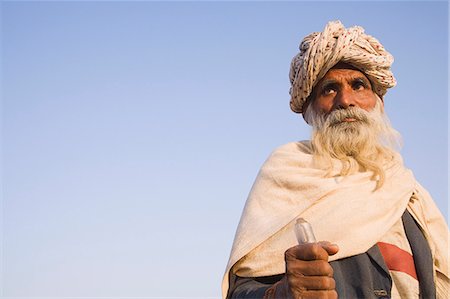 Man holding a walking stick and thinking, Pushkar, Ajmer, Rajasthan, India Stock Photo - Rights-Managed, Code: 857-03192468