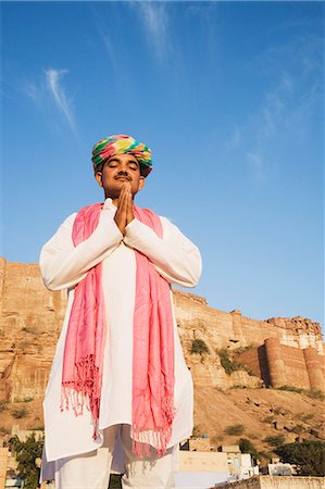 Man in prayer position with fort in the background, Meherangarh Fort, Jodhpur, Rajasthan, India Stock Photo - Rights-Managed, Code: 857-03192554