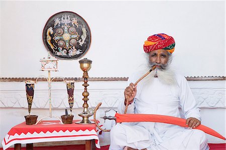 Man holding a sword and smoking, Meherangarh Fort, Jodhpur, Rajasthan, India Stock Photo - Rights-Managed, Code: 857-03192576