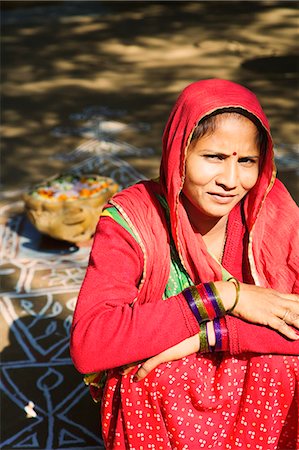Portrait of a mid adult woman smiling with rangoli in the background, Jodhpur, Rajasthan, India Stock Photo - Rights-Managed, Code: 857-03192605