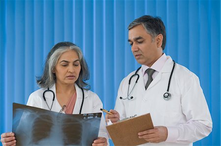 Two doctors discussing an x-ray report, Gurgaon, Haryana, India Stock Photo - Rights-Managed, Code: 857-03554135