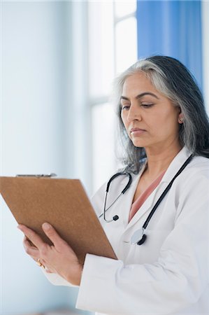 prescription doctor - Female doctor holding a clipboard, Gurgaon, Haryana, India Stock Photo - Rights-Managed, Code: 857-03554142