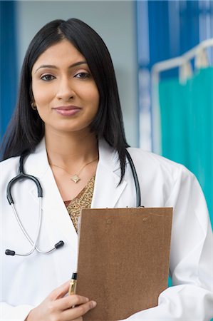 prescription doctor - Female doctor holding a clipboard, Gurgaon, Haryana, India Stock Photo - Rights-Managed, Code: 857-03554193