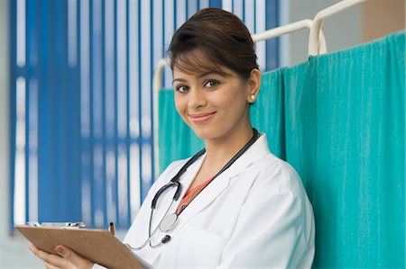 doctor taking notes - Female doctor writing a prescription, Gurgaon, Haryana, India Stock Photo - Rights-Managed, Code: 857-03554204