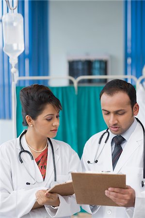 Two doctors discussing a report, Gurgaon, Haryana, India Stock Photo - Rights-Managed, Code: 857-03554229